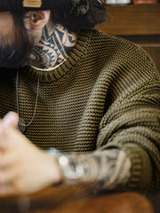 詳細画像: ニットの編み目が立体的に見えるディテール画像。粗い糸で編まれた質感が、ヴィンテージ調の雰囲気を引き出し、耐久性の高さと毛玉の付きにくさを表現。
モデル画像: モデルがヴィンテージ風の重厚な厚手テクスチャーニットセーターを着用している様子。スマイルカーブネックのデザインが映え、ゆったりとしたドロップショルダーで、冬のレイヤードコーディネートにも最適なシルエット。