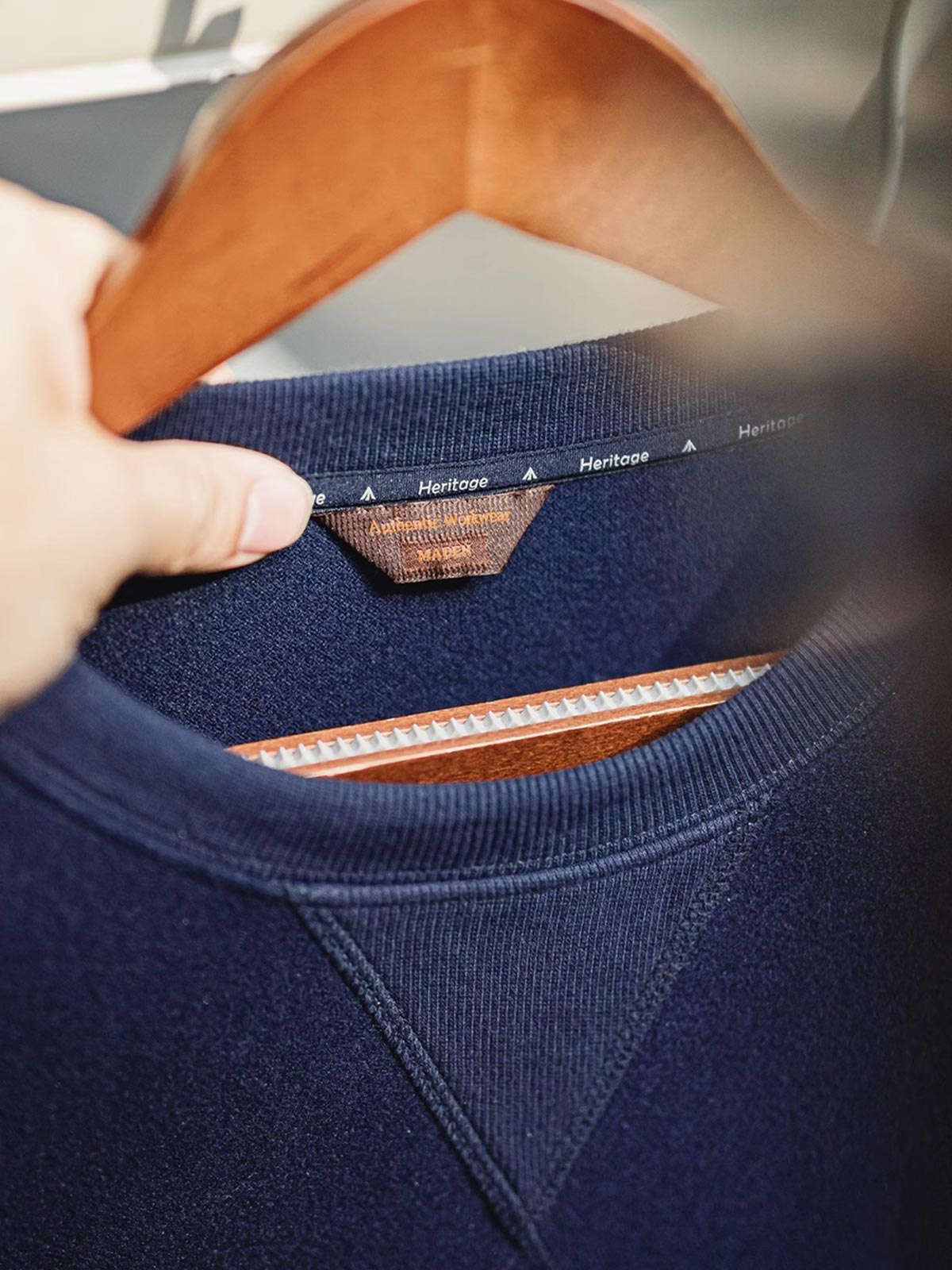 製品画像
「アメリカンヴィンテージ風デザインのウール混クルーネックスウェット全体展示写真。450~460g/m²のヘビーメルトン風ウール混素材を採用し、保温性と実用性を兼ね備えたネイビーカラーの秋冬に最適な一着。」
詳細画像
「アウトドアスタイルを取り入れた斜め配置のパッチポケットと、冷気の侵入を防ぐリブ袖口のディテール写真。高密度ウール混素材の質感と実用的なデザインが際立つスウェット。」