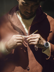 詳細画像:木製の牛角ボタンとアコーディオンポケットのディテールをクローズアップ。クラシックなディテールが、全体の完成度を高めています。
モデル画像:モデルがダッフルコートを着用し、学院風スタイルのカジュアルな冬のコーディネートを提案。