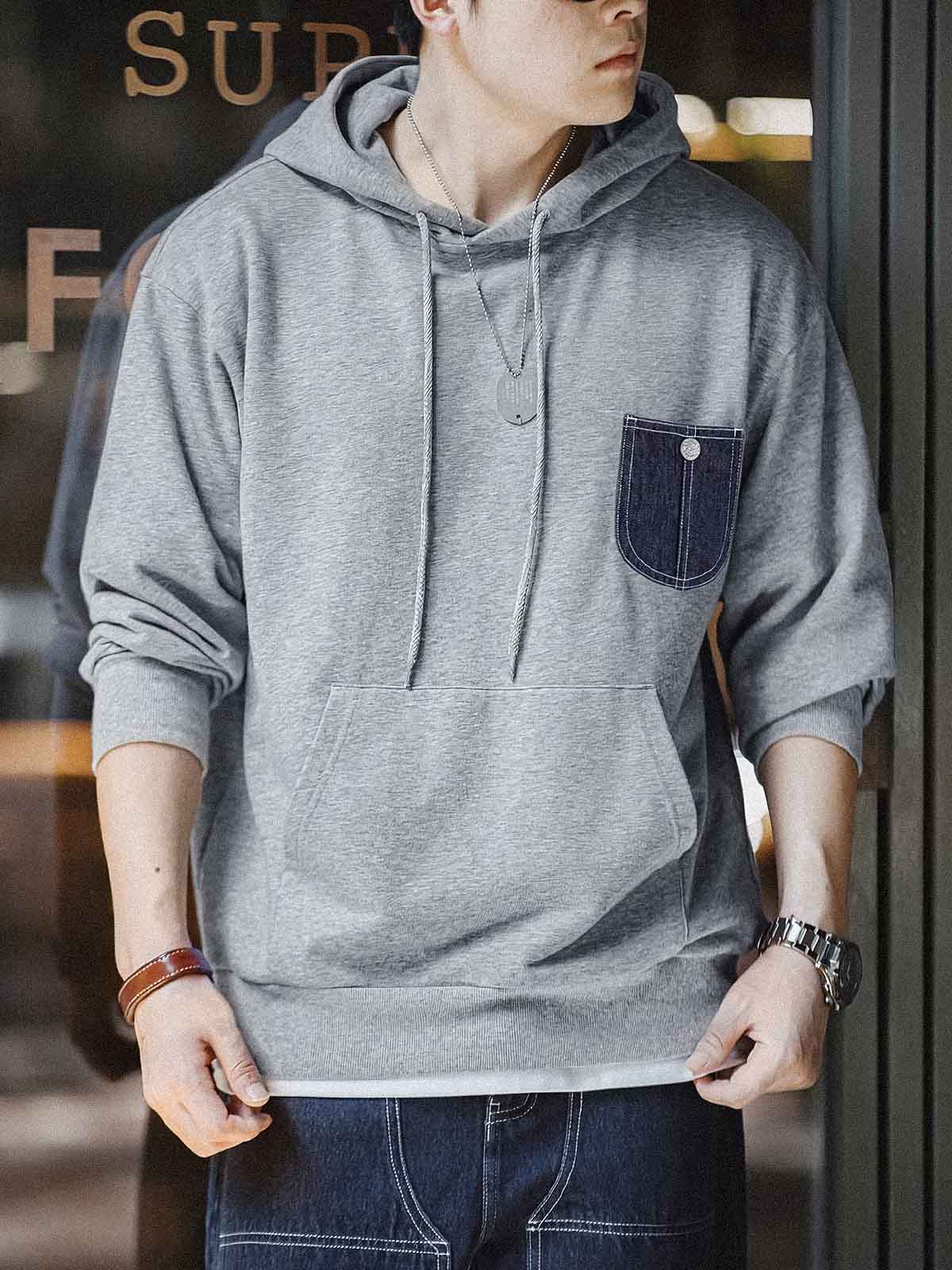 詳細画像:
「霜降り模様のコットン感ストレッチニット生地と、白いステッチと刻印入り銅製ボタンをあしらったデニムポケットのディテールクローズアップ。パッチワークデザインがヴィンテージ感と立体感を強調。」
モデル画像:
「モデルがデニムポケット付き パッチワーク パーカーを着用し、スポーティーなヴィンテージスタイルを披露。ゆったりとしたルーズフィットのシルエットが、カジュアルシーンからスポーツスタイルまで幅広く対応。」