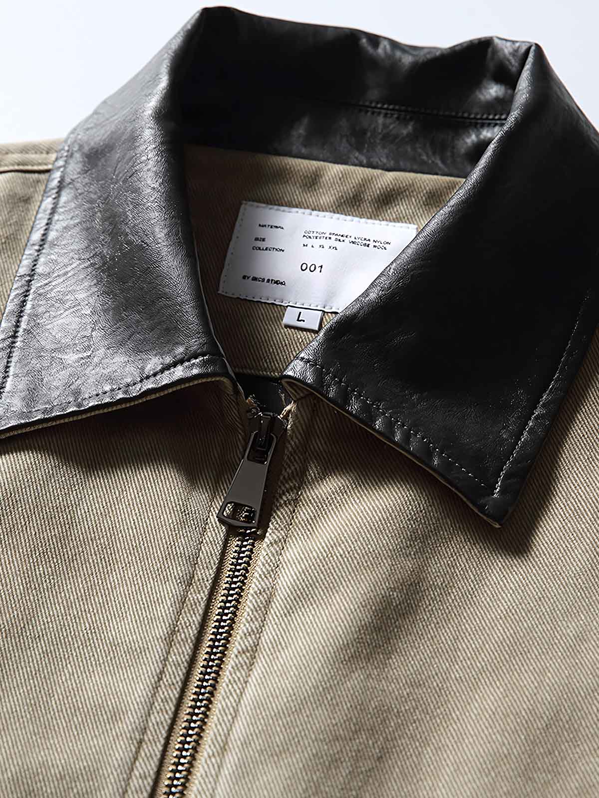 製品画像: レザーカラーワークジャケットの正面展示
詳細画像: ジャケットのレザー襟とジップポケットのディテール展示