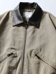 製品画像: レザーカラーワークジャケットの正面展示
詳細画像: ジャケットのレザー襟とジップポケットのディテール展示