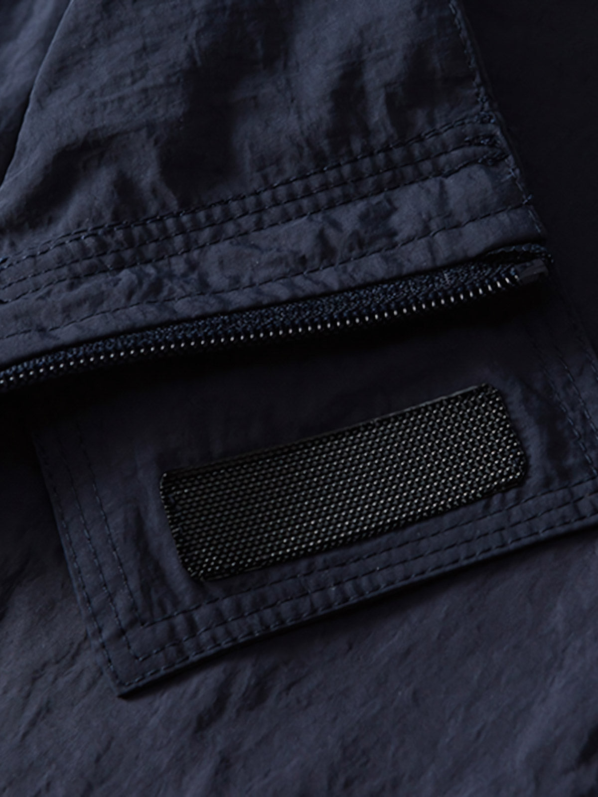 製品画像: 防水・リフレクター付き100%ナイロントレンドスポーツジャケット全体画像。アウトドアや日常使いに適したデザインで、防水性能とリフレクターデザインが際立ちます。
詳細画像: 夜間の安全性を高めるリフレクターデザインと、スタイリッシュな配色のディテールクローズアップ。防水機能とトレンド感を両立した高性能ジャケット。