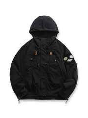 製品画像: エポレット付きフードワークジャケットの正面展示。ミリタリー風デザインと実用性を兼ね備え、防風・防水機能でアウトドアにも最適。エポレットと多機能パッチが特徴的。
詳細画像: エポレットディテールと袖口のパッチ、ドローコード付き裾の調整可能なデザインが際立つ。軽量で着やすい100%ポリエステル素材が防風・防水機能を提供。