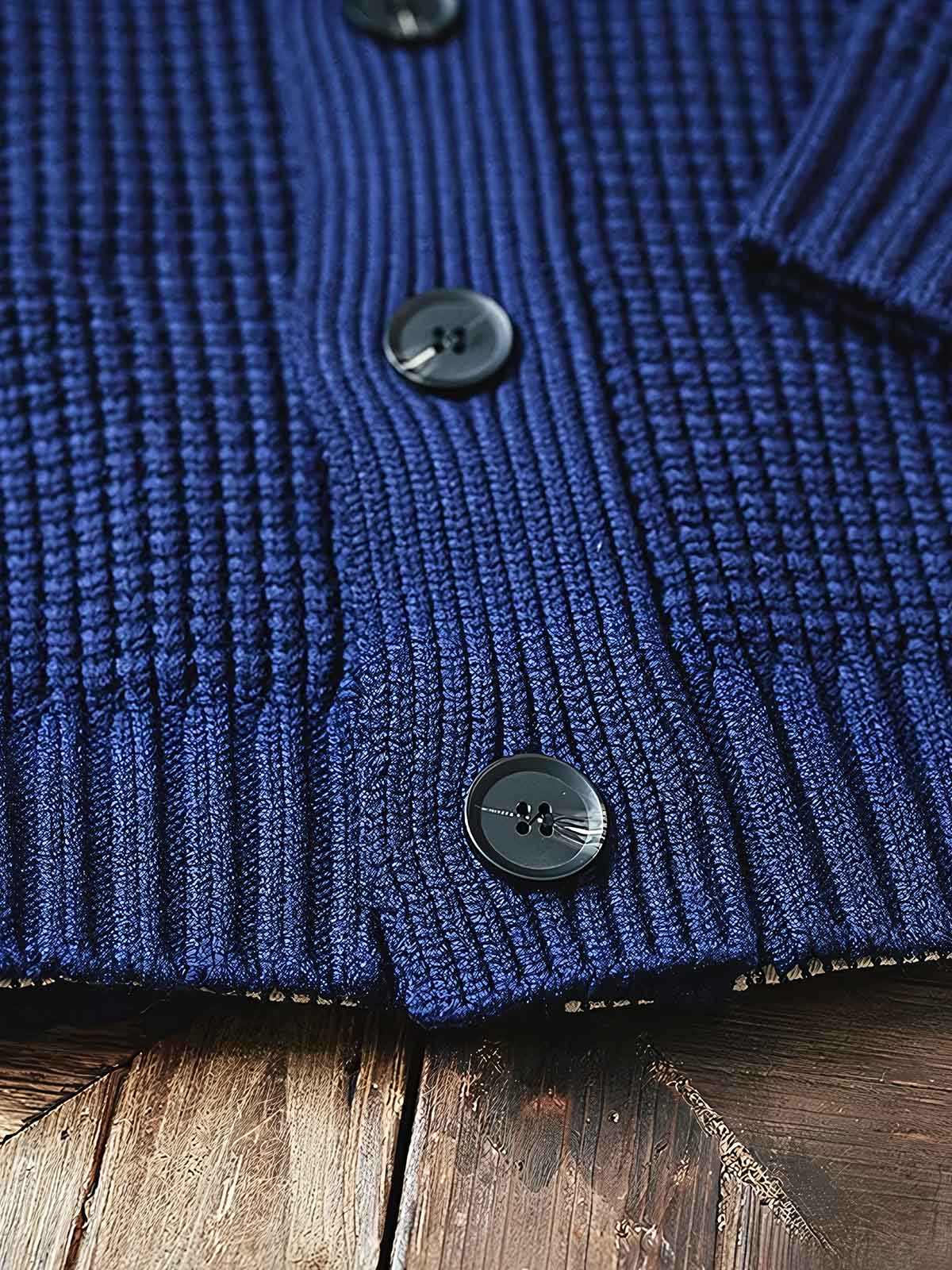 製品画像:
「ラウンドカラー ウール混紡 カーディガンの全体正面展示図。クラシックなワッフル柄デザインとウール65%混紡素材が特徴で、保温性とヴィンテージ感を兼ね備えた冬の定番アイテム。」
詳細画像:
「ラウンドカラー ウール混紡 カーディガンのワッフル柄ディテールとジャカード織り縁部分のクローズアップ。立体感のある柄と丁寧な縁加工が、全体の質感とデザイン性を引き立てます。」