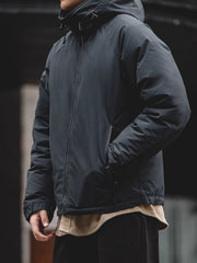 詳細画像
マットな光沢のナイロン生地、取り外し可能な防風フード、裾のエラスティックドローコードが実用性を高め、寒風を防ぎます。多層構造でダウンの膨らみを保ちつつ、優れた保温性を発揮します。シンプルでスリムなラインが特徴。
モデル画像
ECWCS L7スタイルのフード付きダウンジャケットを着用したモデル、冬の寒さにも対応できる優れた保温性とスタイリッシュなデザインが際立つ。