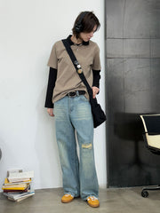 モデル画像: モデルが着用したアメリカンヴィンテージ風の破れストレートジーンズの展示