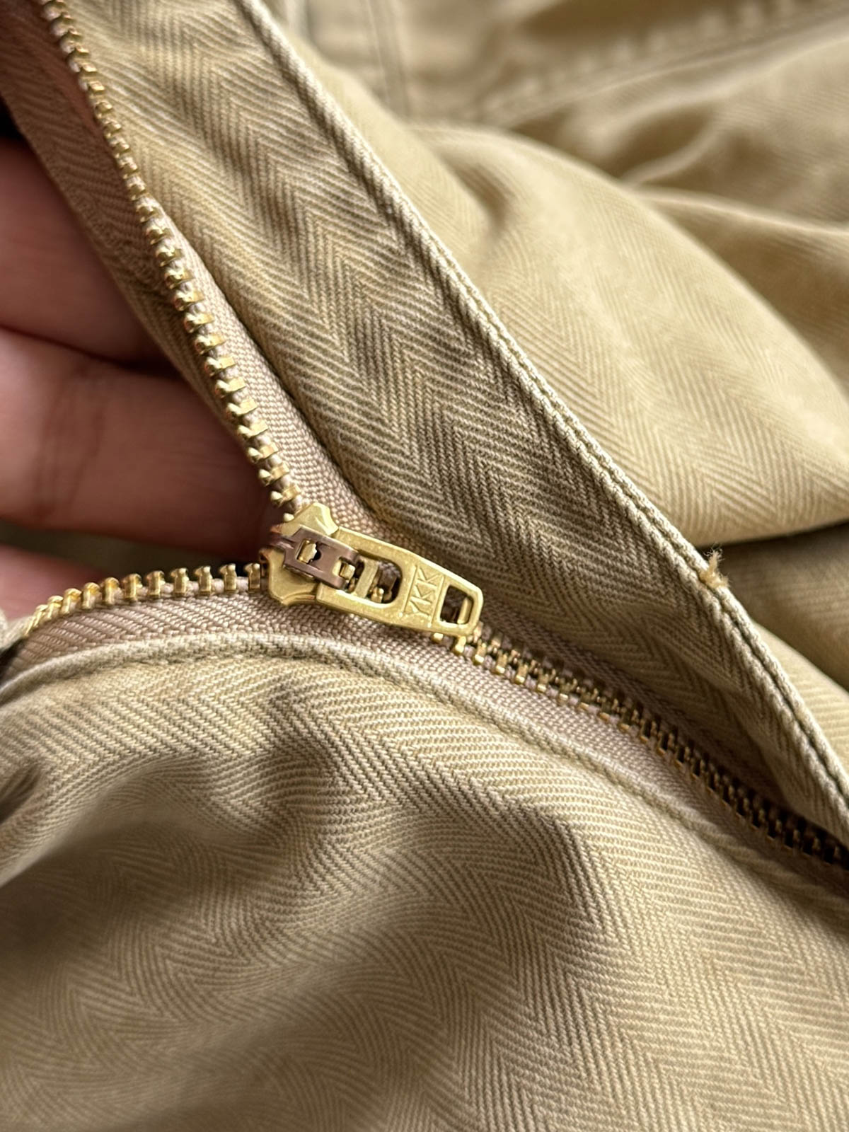 製品画像
「ヘビーウォッシュ加工が施されたヘリンボーン柄コットン素材のアメカジワークパンツ全体イメージ。自然な色褪せやダメージ感、パッチワークディテールが特徴。」
詳細画像
「ヘリンボーン柄コットン素材とヘビーウォッシュ加工によるダメージデザイン、パッチワークディテールをクローズアップ。YKK純銅ジッパーが耐久性を高める。」