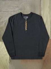 製品画像
クラシックな刺繍入りデザインの改良型ヴィンテージヘンリーネック 長袖Tシャツの正面全体画像。高品質なアメリカ産ピマコットン素材を使用した一着。
詳細画像
刺繍入りの近似色前立てとダブルステッチ仕上げ、リブ仕様の袖口ディテールをクローズアップした画像。美しい縫製と耐久性が特徴。