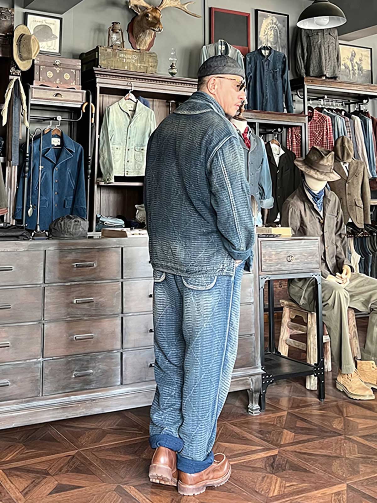 詳細画像: チャイナボタンのクラシックなディテールとストーンウォッシュ加工による深みのある藍色を強調した写真。
モデル画像: Indigo 藍染め スタンドカラーチャイナボタン コートを着用したモデルによる、洗練されたヴィンテージスタイルのコーディネート写真。