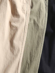 詳細画像: ヘリンボーンのディテールとパンツの裾デザインの特写