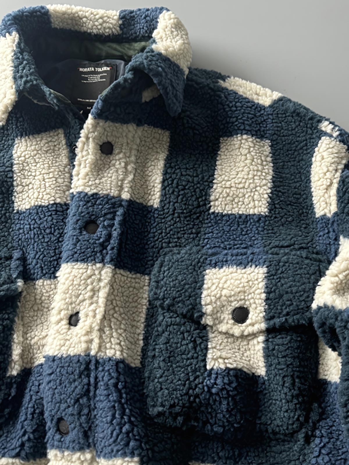 製品画像: ヴィンテージトライバルパターン シープボアシャツの正面画像、トライバルパターンが際立つデザイン。
詳細画像: シープボア素材とトライバルパターンのディテール画像、ヴィンテージ感を強調。