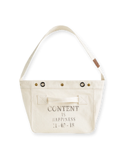 19世紀末ニュースボーイスタイルとモーターサイクル要素を融合したアメリカンヴィンテージニュースボーイバッグ。未染色コットンキャンバス素材、大容量収納、耐久性のあるブロンズ金具が特徴