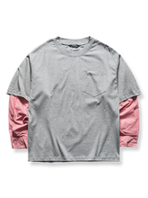 配色切り替えとレイヤード風デザインを施したクルーネックTシャツ。ゆったりシルエットと袖の切り替えが特徴。