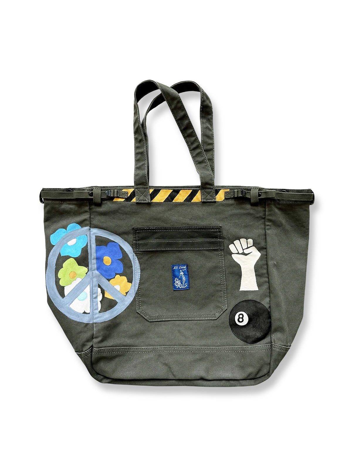 手描きデザインとウォッシュ加工を施したヴィンテージ風キャンバストートバッグ。大容量内ポケットとショルダーストラップ付きで実用性も高い。