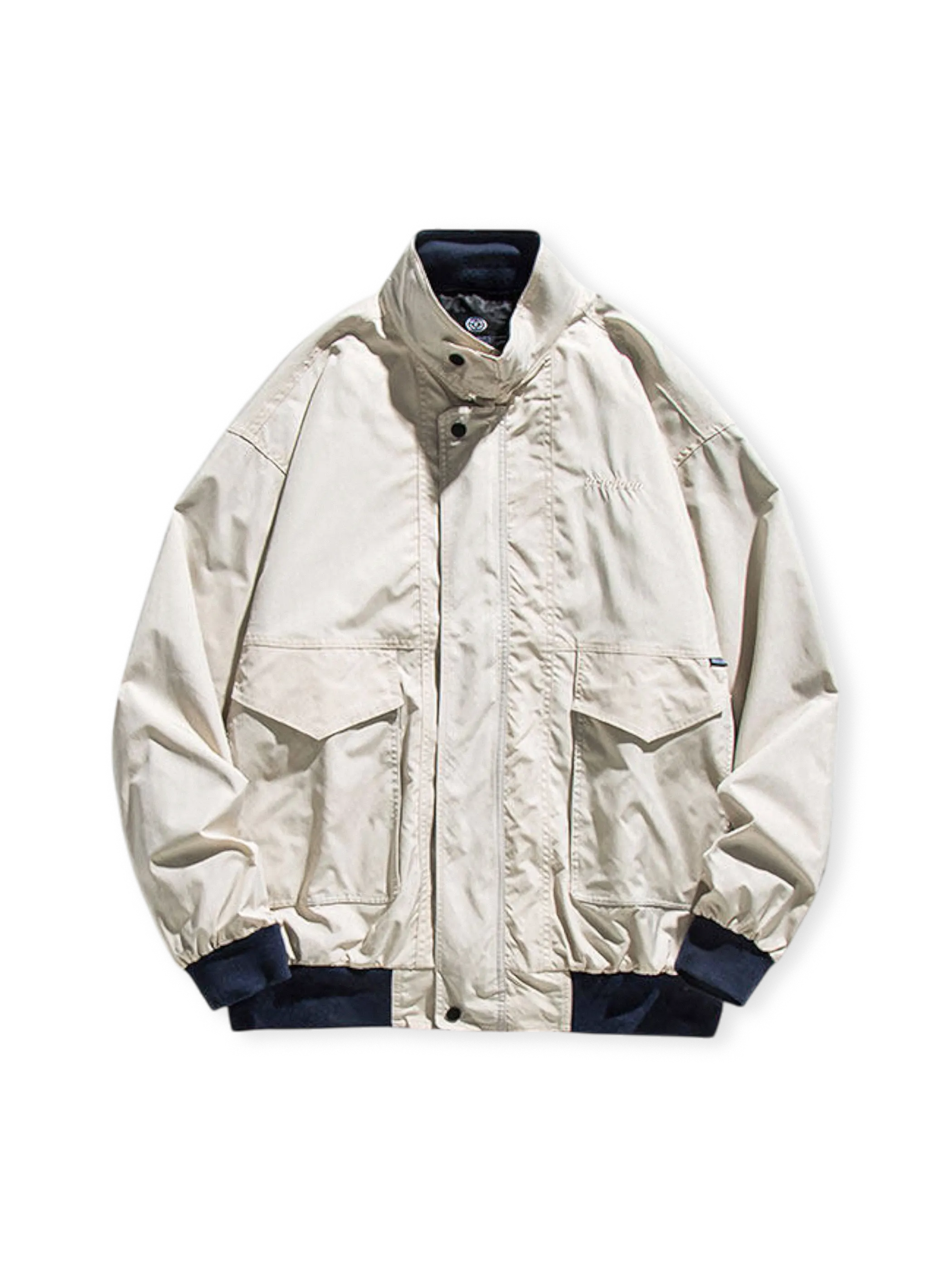 大容量フラップポケットとスタンドカラーを持つ耐摩耗ポリエステル製ワークジャケット。伸縮性リブ袖口と裾が特徴。