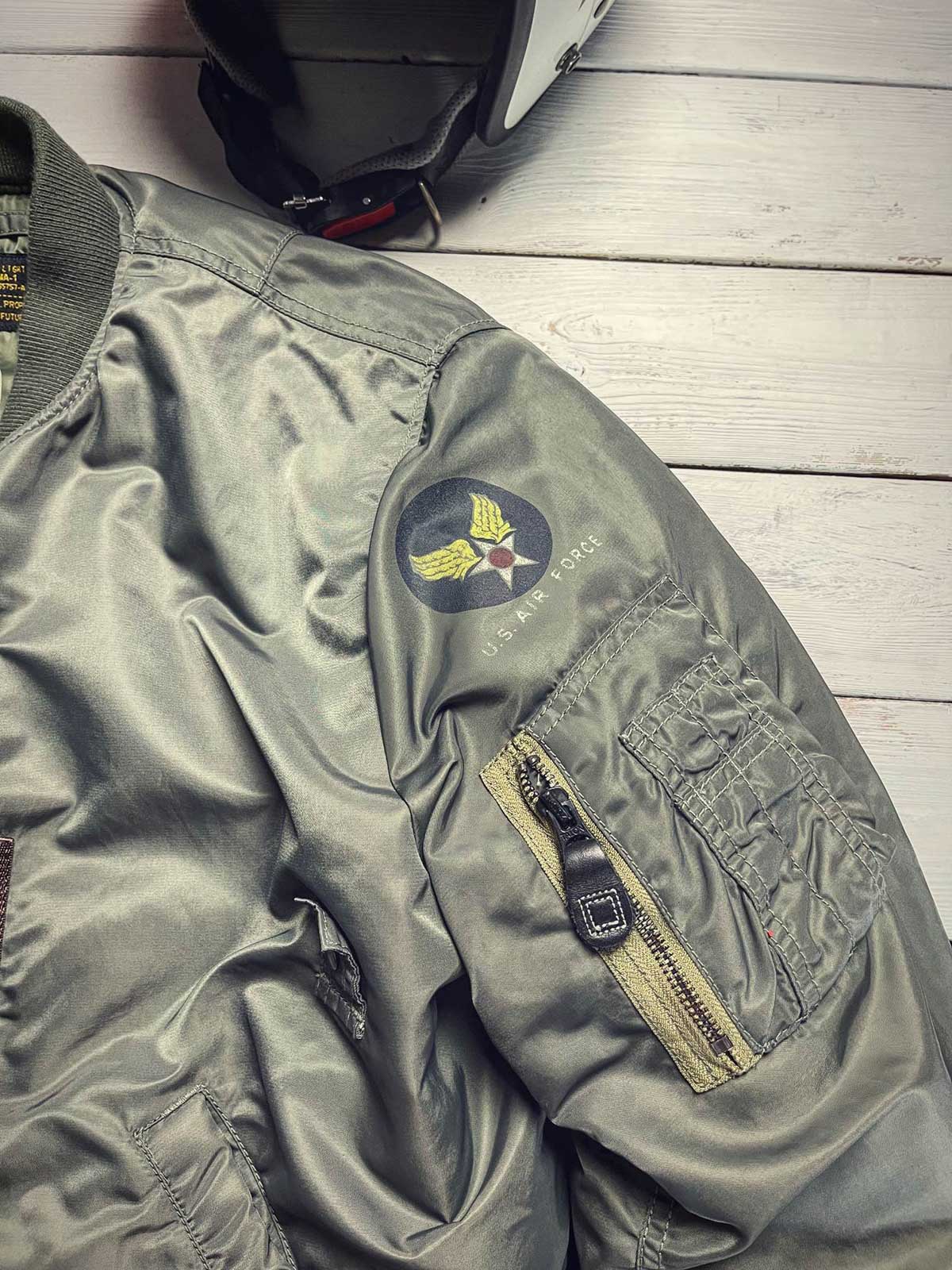 製品画像: 両面ウール使用のMA-1リバーシブルミリタリーフライトジャケット全体画像
詳細画像: フライトバッジとIDEAL製レザー引手のディテール画像