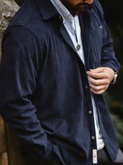 詳細画像:胸元のリベットデザインと裾のNAVAJOラベル。ヴィンテージ感のあるディテール。
モデル画像:モデルが着用したコーデュロイシャツの全身コーディネート。秋冬向けのカジュアルなルーズフィットスタイル。