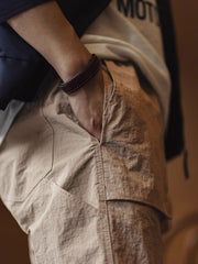 製品画像: 美式OG107マルチポケットカジュアルストレートパンツの全体画像。パンツの全体的なシルエットとデザインが強調されています。
詳細画像: パンツのダブルレイヤーポケットのディテール画像。ポケットの補強部分が際立っています。