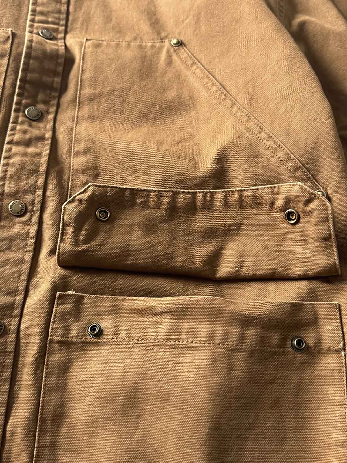 製品画像: アウトドアハンティング(狩猟)スタイルヴィンテージウォッシュ加工ワークシャツの全体画像。シャツの全体的なシルエットとデザインが明確に分かる。
詳細画像: ダブルポケットのデザインとヴィンテージ加工のディテール画像。シャツの質感と耐久性が強調されている。