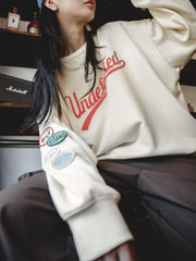 カレッジ風ラグランスリーブスウェットシャツ