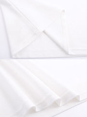 アイビーリーグ風ポロシャツの詳細、襟と袖口の緑と赤のストライプデザインおよび胸元の刺繍ディテールをクローズアップ。