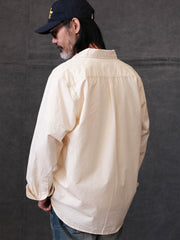 詳細画像: クラシックルーズフィット長袖シャツの高品質な縫製と樹脂ボタンのディテール
モデル画像: ルーズフィットのホワイトシャツを着用したモデルのコーディネート、都会的な通勤スタイル