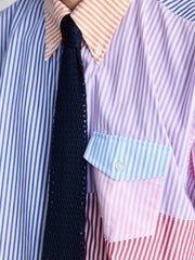 シャツの精緻なボタンダウンカラーとカラーブロックパターンのクローズアップ。