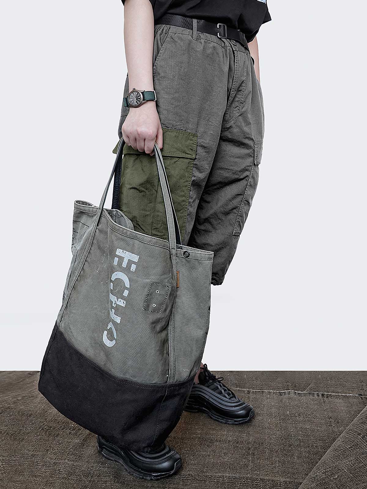 詳細画像: トートバッグのひまわり柄パッチワークとウォッシュ加工が施されたディテール画像。独特のデザインと素材のコンビネーションが特徴。
モデル画像: ひまわり柄キャンバストートバッグを使用したカジュアルコーディネート例。日常使いにも適した実用性の高いデザイン。