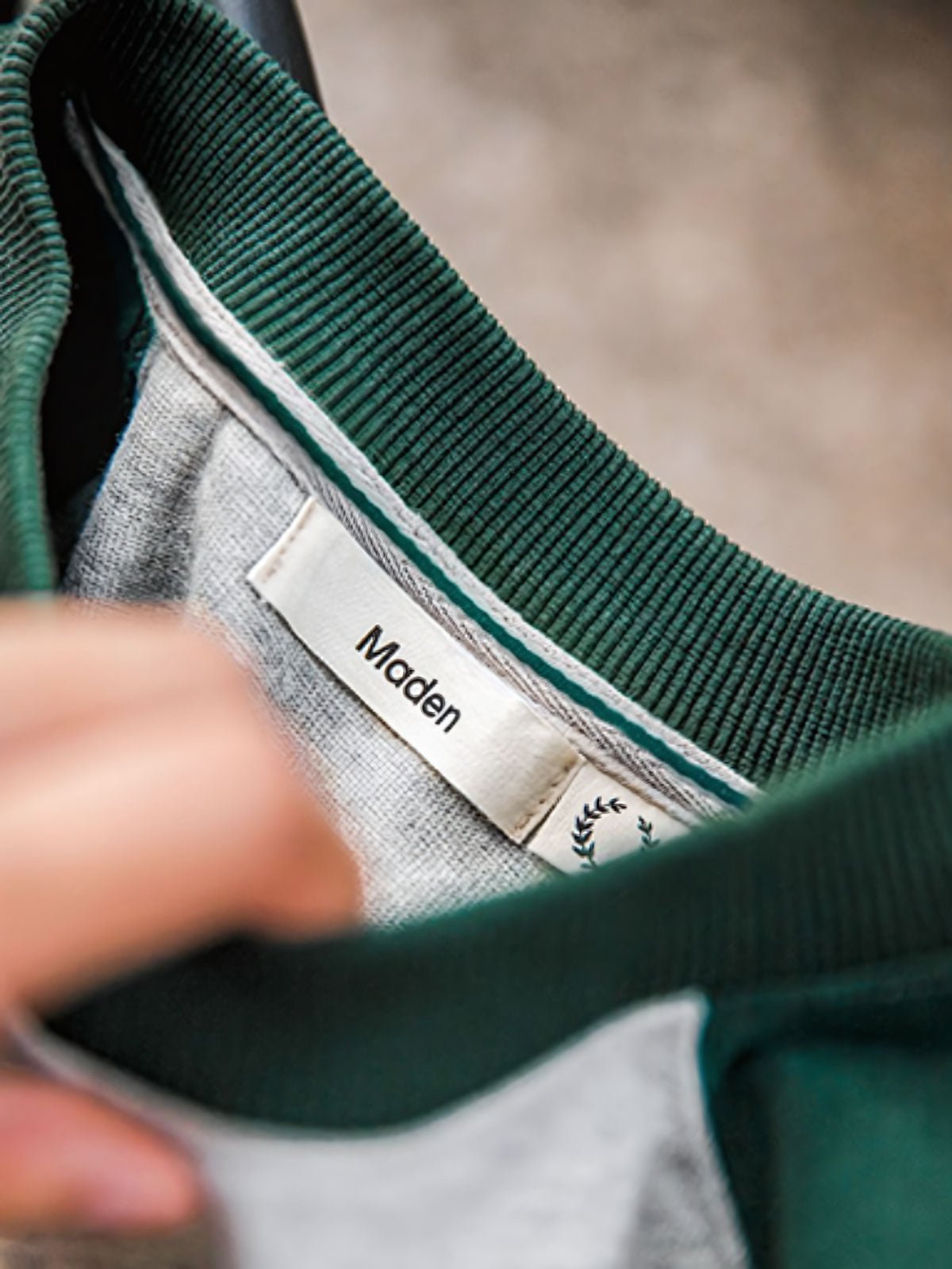 詳細画像:Tシャツのエンブレムプリントと配色袖口のディテール