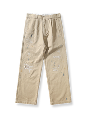 ヴィンテージダメージ刺繍ルーズチノパンツ。