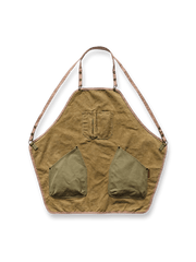 ウォッシュ加工を施したキャンバス素材のヴィンテージ風パッチワークエプロン。胸部と下部にポケットを備えたユニセックスデザイン。