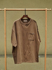 ハンドメイド泥染めエジプシャンコットンポケットTシャツのディテール画像、手刺し子装飾と独特な泥染め効果を示しています