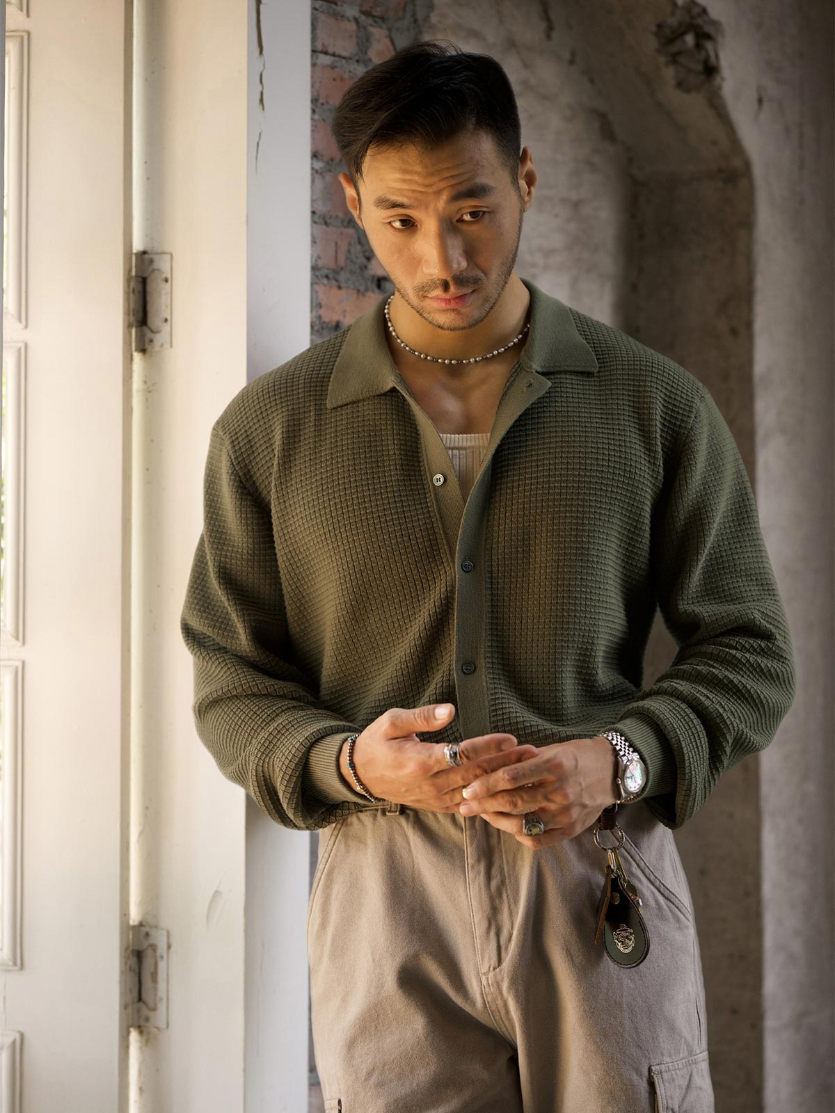 詳細画像: ワッフル編みのテクスチャとキューバシャツ風襟のディテールをクローズアップ
モデル画像: 男性モデルが着用するキューバシャツ風ニットシャツ - 全体スタイルと着こなし例