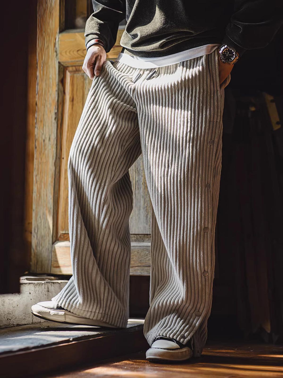詳細画像（Detail Image）:
サイドのボタンデザイン、ウエスト部分、コーデュロイ素材の質感をクローズアップした画像。ボタンの開閉や生地の触感が伝わるようなディテールが特徴。

モデル画像（Model Image）:
実際に着用したモデルが、ヴィンテージ風コーデュロイボタン付きストレートスウェットパンツをスタイリッシュに着こなしているシーン。シルエットやフィット感が分かるように工夫された着用写真。
