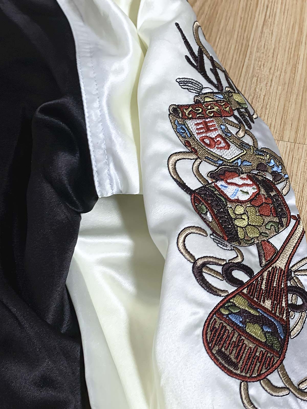 製品画像: リバーシブル シルク刺繍 横須賀 宝船 七福神 ジャケット全体画像、伝統的な横須賀刺繍と幸運の象徴デザイン

詳細画像: 七福神宝船と赤鬼、虎の刺繍ディテール、精緻なシルク刺繍で仕上げられた高級感あるデザイン