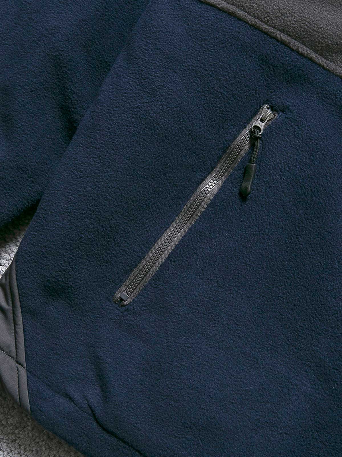 製品画像
カラーブロックフリースジャケットの正面画像。カラーブロックデザインが特徴的な、軽量で保温性に優れたフリース素材を使用した秋冬向けの多ポケットジャケット。

詳細画像
フリース素材を使用したカラーブロックデザインの多機能ポケットが特徴的なジャケットのディテール。収納力を高めるポケットと、立ち襟デザインが秋冬の寒さから守ります。