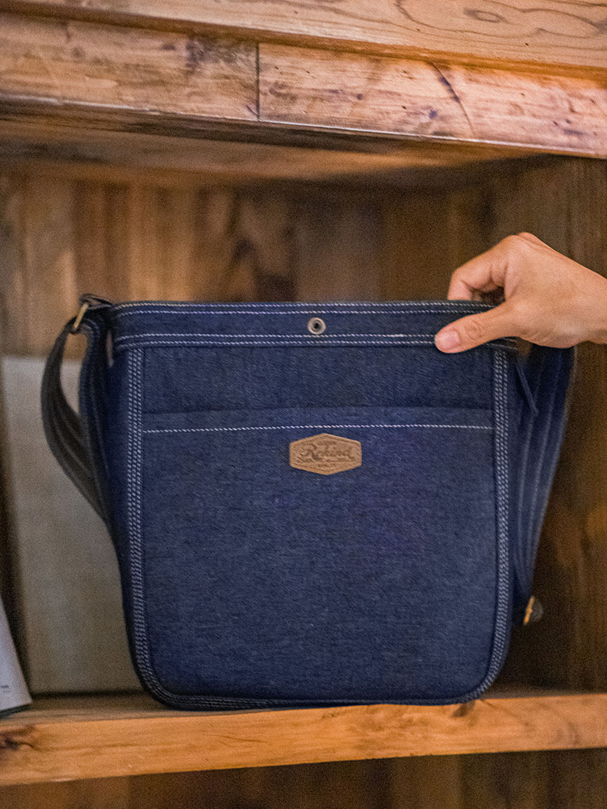 モデルがデニムメッセンジャーバッグを使用し、ヴィンテージ感あふれるカジュアルコーデを披露