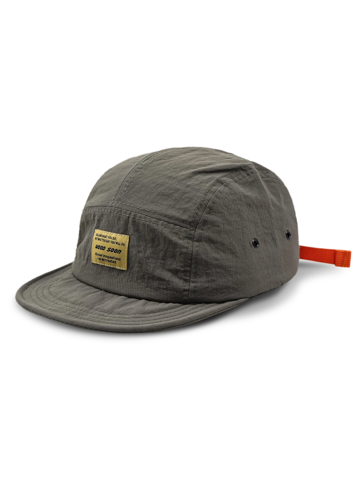 エクスプローラーハットの通気孔とオレンジ色のプルタブのクローズアップ、耐摩耗性に優れたナイロン素材。