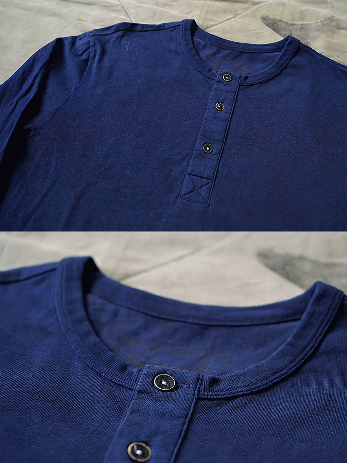 製品画像
伝統的な藍染め技法を施したヘンリーネック長袖Tシャツの全体画像。260gの厚手コットン素材とクラシックなデザインが際立つ一枚。

詳細画像
藍染めによる独特なグラデーションと、染色されたコットン縫い目の細部を強調したクローズアップ画像。1点ごとに異なる色合いや職人の手作り感が魅力。