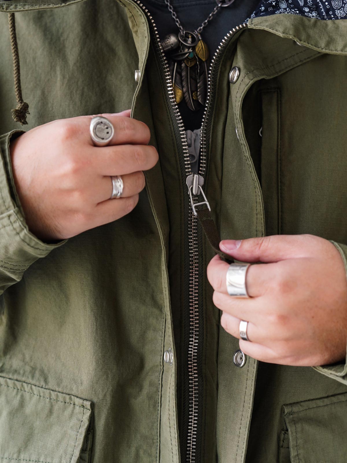 詳細画像
「ハードシェルのような質感を持つチェック柄ファブリックとペイズリー柄コットン裏地、隠しジップポケットや大型スナップボタンのディテールクローズアップ。」

モデル画像
「モデルがヴィンテージ風 通勤用 トレンチジャケットを着用し、大容量ポケットとルーズフィットシルエットで快適さとスタイリッシュさを両立した通勤コーディネート。」