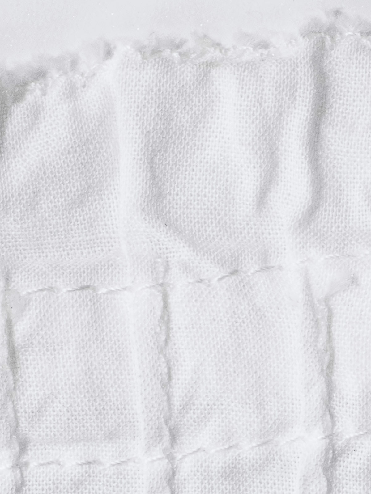 プリーツのディテールと調整可能なネックラインのクローズアップ