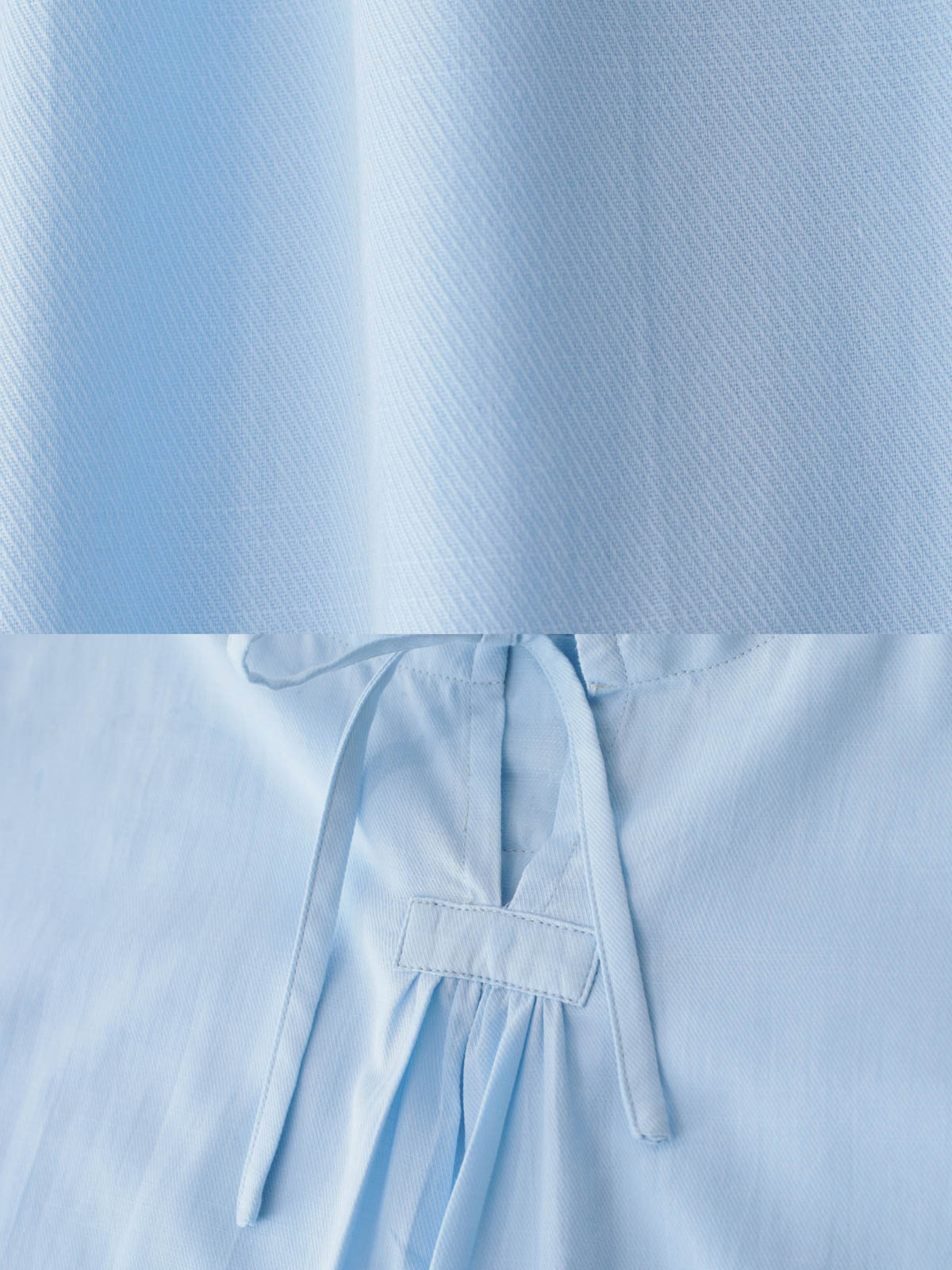 ラウンドネックのドローコードと非対称な裾のディテール。