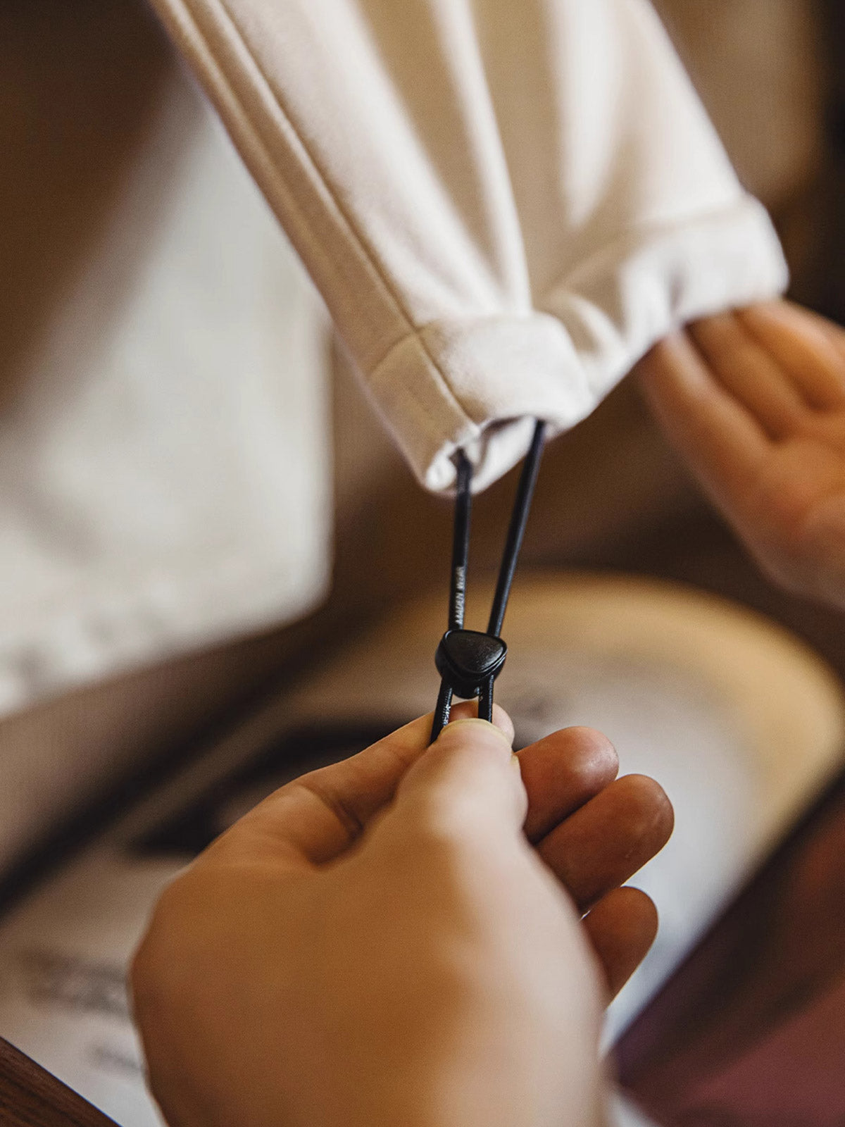 外側の斜めポケットとウエストのドローコードデザインの詳細画像