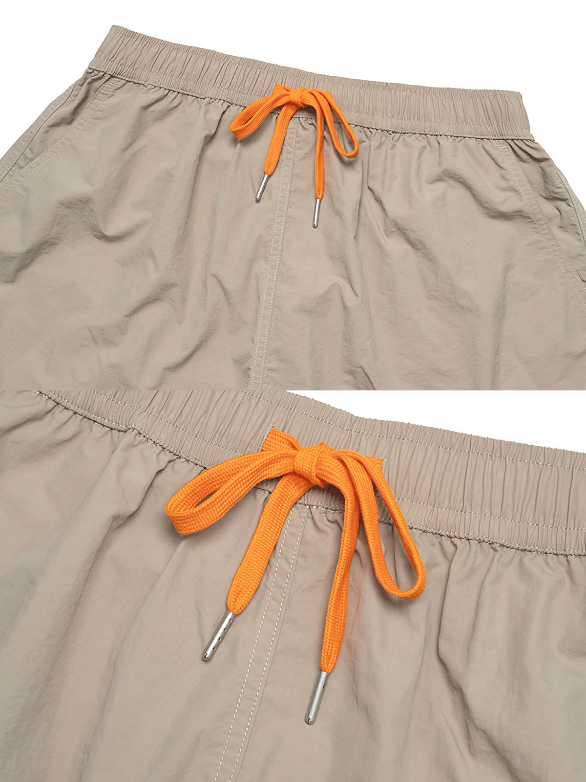 ナイロンショートパンツのクローズアップ。精密な縫製、コンピューター刺繍のロゴ、環境に優しいボタンのディテールが見えます。