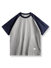 MA‑1風ペンポケット付きのヴィンテージラグランスリーブベースボールシャツ。