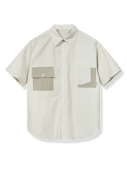 非対称ポケットとコントラストカラーが特徴の通気性良好な純綿ワークシャツ