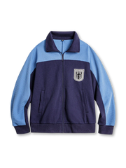 ツートーン配色の襟付きジップアップトレーニングジャケット、胸に盾型パッチ付き