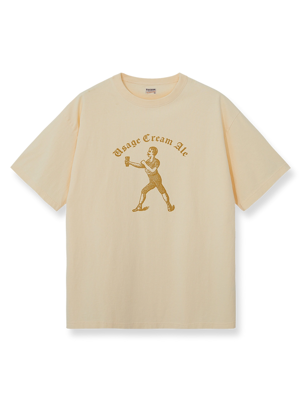 DRINKING TEAMロゴのジンジャーイエロー×アイボリー配色ヴィンテージTシャツ。