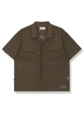 レース刺繍が施されたコットンニットシャツ。